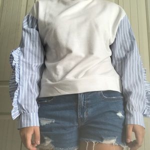 White sweater with blue lined sleeve